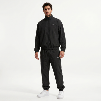 Nike NOCTA Track Complete tracksuit in Black - model wearing full outfit, front view