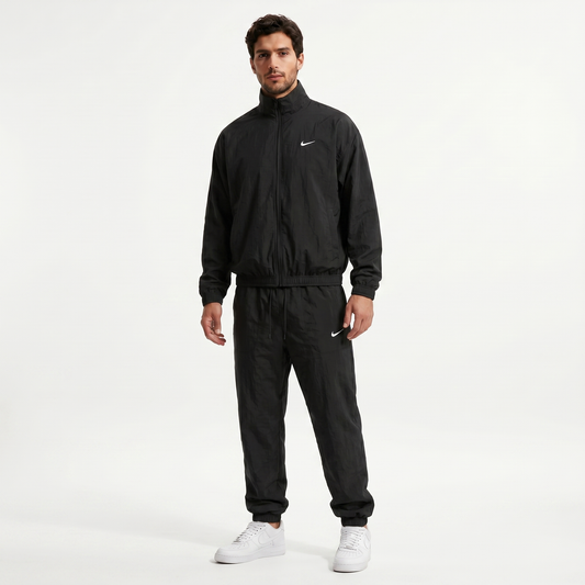 Nike NOCTA Track Complete tracksuit in Black - model wearing full outfit, front view